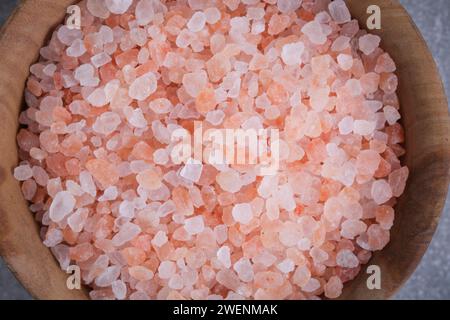 Wooden cup with pink Himalayan salt in closeup Stock Photo