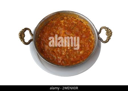 Turkish breakfast dish Menemen, eggs, tomatoes and peppers in a pan. isolated white background Stock Photo