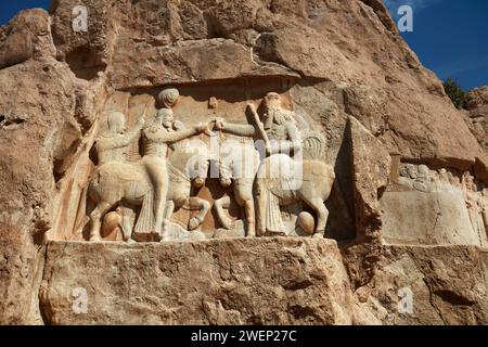 The Investiture of Ardashir I, relief depicts the Persian king Ardashir I receiving the sovereignty ring from god Ahura Mazda. Naqsh-e Rostam, Iran. Stock Photo