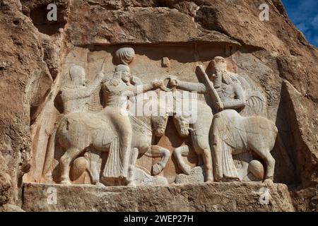 The Investiture of Ardashir I, relief depicts the Persian king Ardashir I receiving the sovereignty ring from god Ahura Mazda. Naqsh-e Rostam, Iran. Stock Photo