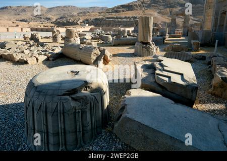 Pieces of fallen ancient columns in Persepolis, ceremonial capital of the Achaemenid Empire (550–330 BC), Iran. Stock Photo