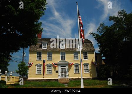 An American flag is raised outside the historic John Paul Jones House, considered the father of the American Navy, in Portsmouth New Hampshire Stock Photo