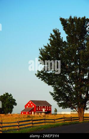 A lone red barn stands in a field and once saw a decisive victory in the American Civil War at Gettysburg National Military Park Stock Photo