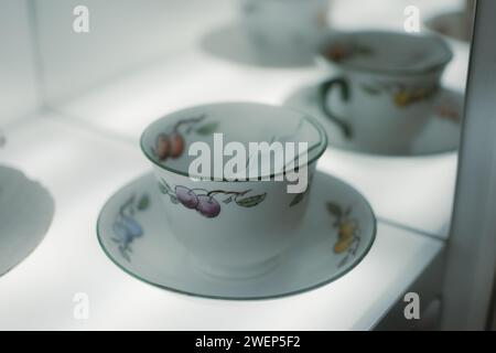 Cups and saucers adorned with charming fruit designs Stock Photo