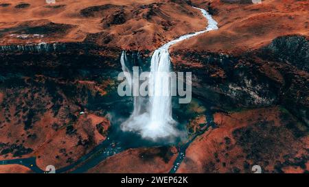 Aerial view of cascading waterfall in vibrant coastal landscape Stock Photo
