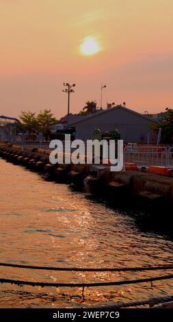The setting sun glistened on the water. Stock Photo