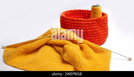 Yellow knitted sweater on a white background. Knitting concept. Knitted and winter clothes Stock Photo