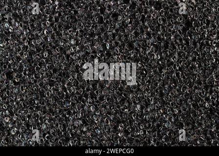 Foam rubber texture close up. High quality macro texture of dark grey foam rubber sponge. Stock Photo