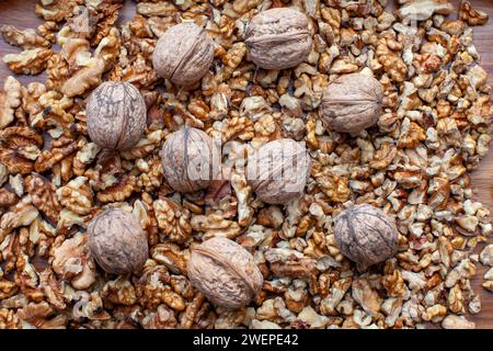 crushed and whole walnuts arranged together Stock Photo