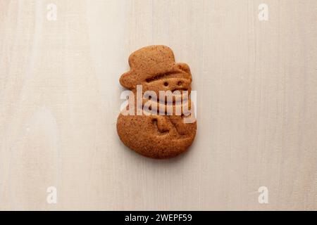 snowman gingerbread cookie isolated on white wooden background Stock Photo