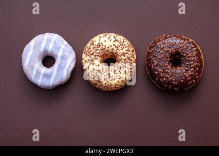 three ring doughnuts isolated on brown background Stock Photo