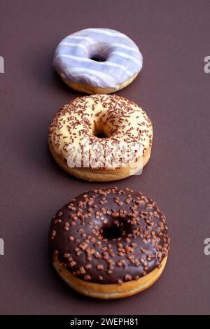 three ring doughnuts isolated on brown background Stock Photo