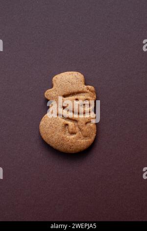 snowman gingerbread cookie on brown background Stock Photo