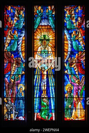 The Holy Trinity. A stained-glass window in Igreja de Nossa Senhora de Fátima, Lisbon. Stock Photo