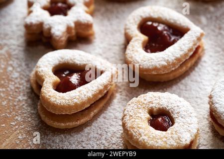 Linzer Christmas cookies in the shape of hearts filled with strawberry marmalade and dusted with sugar Stock Photo