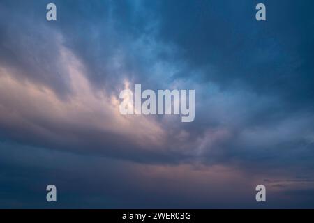 Dramatic pastel colored clouds at sunset. Cloudscape photo. Stock Photo