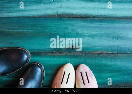 Men's leather dress shoes with cedar wood shoe trees shot from table top view. Overhead image. Stock Photo