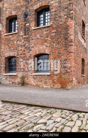 A vertical shot of a brick building featuring windows Stock Photo
