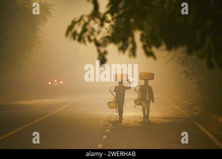 New Delhi, India. 26th Jan, 2024. NEW DELHI, INDIA - JANUARY 26: Two street vendors heading out on a cold morning near KG Marg, on January 26, 2024 in New Delhi, India. (Photo by Ajay Aggarwal/Hindustan Times/Sipa USA ) Credit: Sipa USA/Alamy Live News Stock Photo