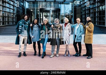 Portrait of diverse business people team posing over corporate office building Stock Photo