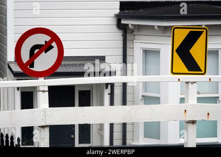 Road signs in front of old wooden houses, Mount Victoria, Wellington, North Island, New Zealand Stock Photo