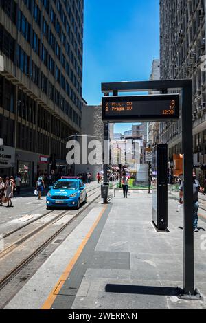 West view of Sete de Setembro street in downtown as saw from Colombo VLT tram station in the middle of the street under summer afternoon blue sky. Stock Photo