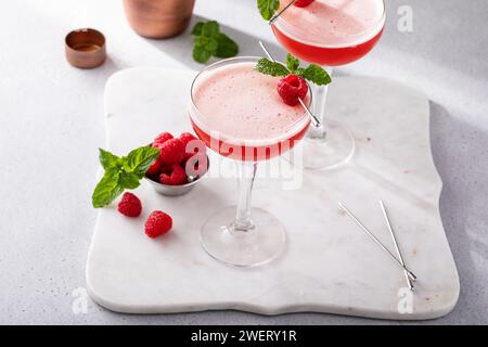 Raspberry martini in coupe glasses, elegant berry drink idea Stock Photo