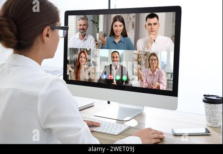 Woman having video chat with coworkers at office Stock Photo