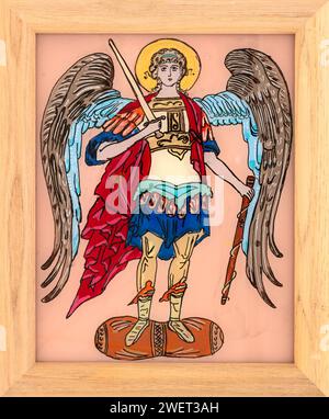 Icon painted on reverse glass in the naive orthodox style of Eastern Europe depicting Archangel Michael. Framed icon. Stock Photo