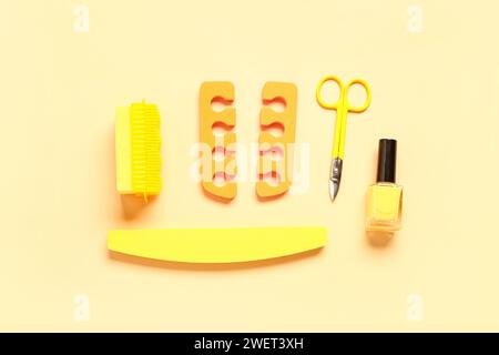 Set of professional tools for pedicure with nail polish on yellow background Stock Photo
