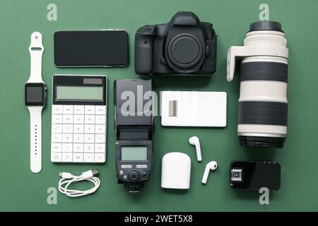 Composition with different modern gadgets on green background Stock Photo