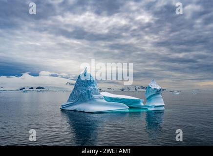 Strange shaped iceberg floating in the water near Antarctica. Stock Photo