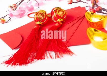 Chinese New Year red packet and golden ingot. Chinese New Year celebration concept. Stock Photo