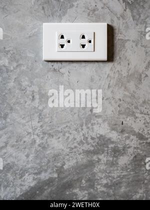 white plug socket on the room wall Stock Photo
