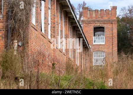 Exterior of abandoned brick buildings with overgrown fields Stock Photo ...