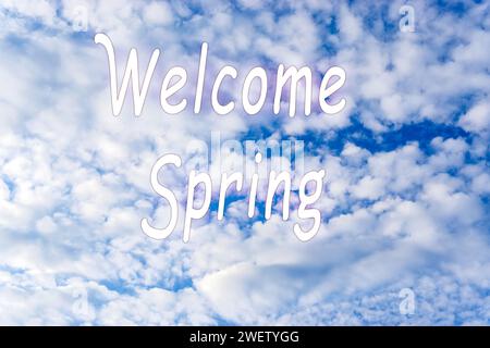 Blue sky with clouds and words, Welcome spring springtime. Spring background Stock Photo