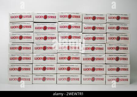 Many packs of British American Tobacco Lucky Strike cigarettes isolated on white background Stock Photo