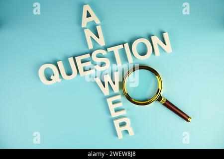 Question and Answer alphabet letters with magnifying glass on blue background Stock Photo