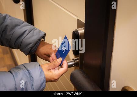Woman hand using electronic smart key card to unlock door in hotel or house. Digital lock, door access control, contactless concept. Closeup, copy Stock Photo