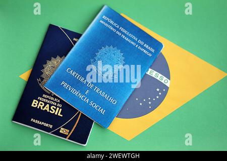 Passport of Brazil and work card with brazilian reais money bills on ...