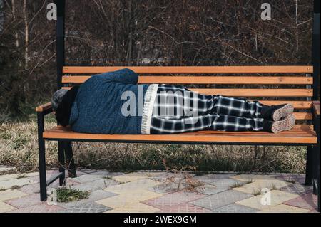 homeless elderly old man lies sleeping on a park bench in autumn Stock ...