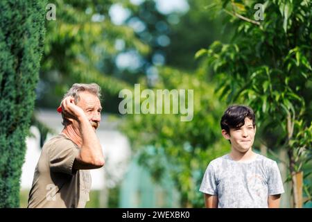 Man playing a game of darts. He needs concentration and perfection to win Stock Photo