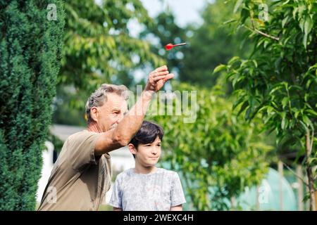 Man playing a game of darts. He needs concentration and perfection to win Stock Photo