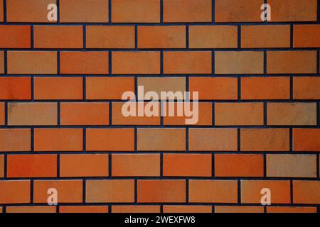 red shiny brick wall, wide panorama of masonry, bricklaying. Stock Photo