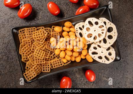 An assortment of various snacks for beer arranged on a dark background, seen from a top-down perspective. The snacks and beverages create an inviting Stock Photo