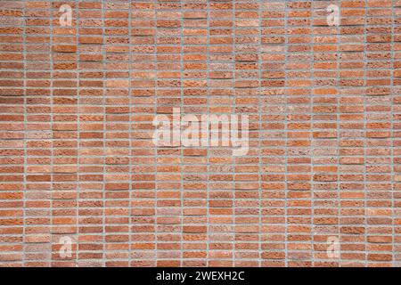 red shiny brick wall, wide panorama of masonry, bricklaying. Stock Photo