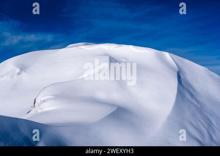 Structures of drifted snow on a hill above Passo Rolle pass in winter. Stock Photo