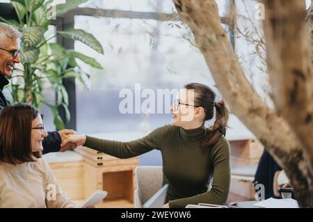 Group of corporate colleagues collaborating and analyzing statistics for business growth. Stock Photo