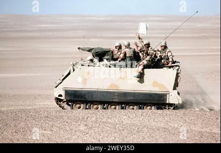 American troops, aboard an M113 armored personnel carrier, wave a ''white flag'' during their participation in Exercise BRIGHT STAR '82 DF-ST-85-03572. Stock Photo