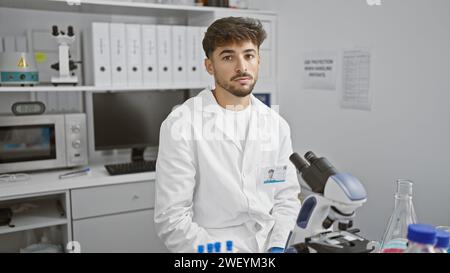 Young arab man scientist using microscope at laboratory Stock Photo